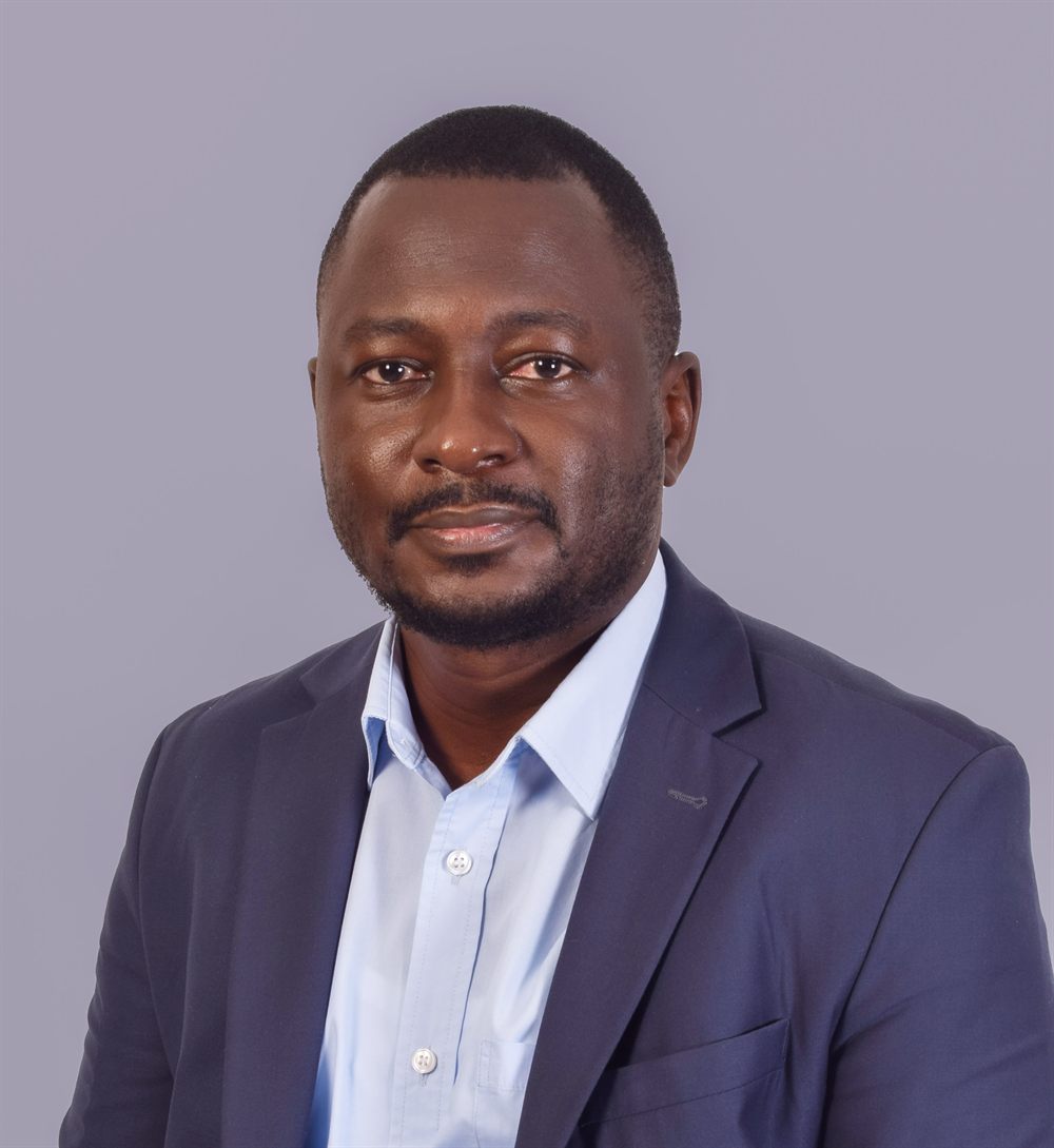 Formal professional portrait of Dr Bob Achila
